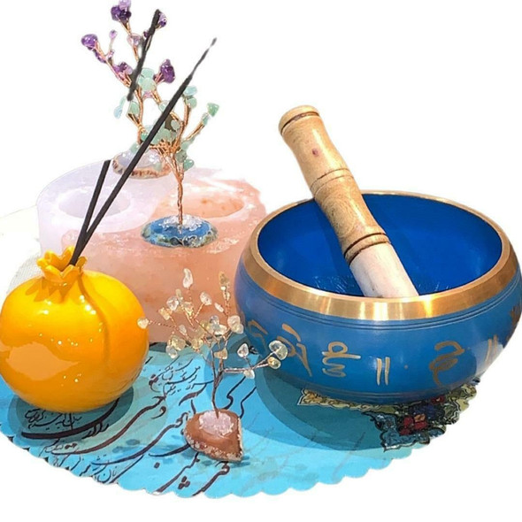 A premium 5-inch handmade Tibetan singing bowl featuring an antique hand-hammered finish, shown with a wooden striker and cushion.