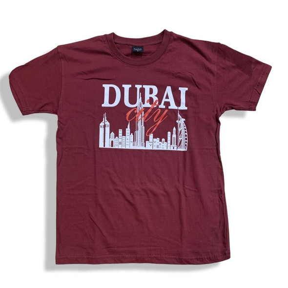 A professional product presentation of the exclusive maroon Dubai souvenir t-shirt from a premier UAE gift shop.