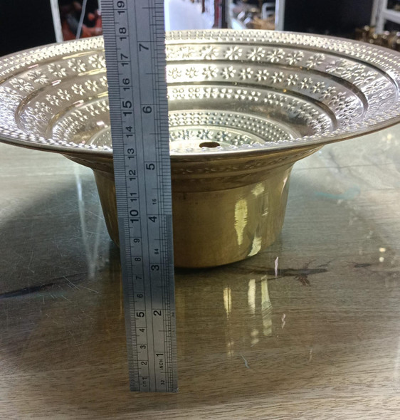A detailed view of an ornate Arabic brass pitcher, reflecting timeless craftsmanship and cultural hospitality.