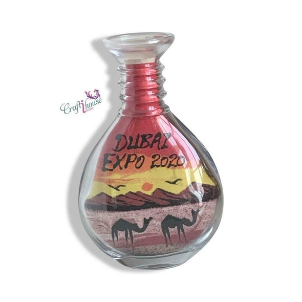 Three-quarter studio perspective of the round, flat-faced 15 cm cultural keepsake sand vial, showcasing the flawless glass construction and the precise positioning of the shifting sand grain layout.