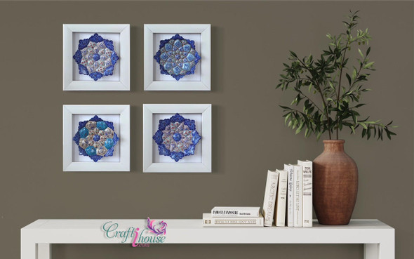A stunning gallery wall arrangement of four circular embossed copper plates set against a dark accent wall.