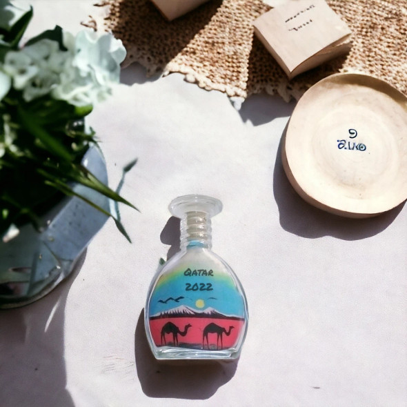 Detailed view of the vibrant, hand-layered sand patterns in a collector’s sand bottle.