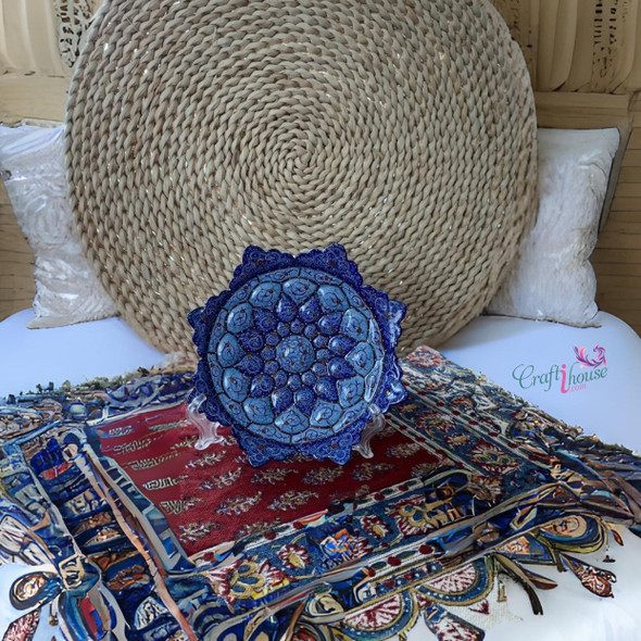 A professional product presentation of the exclusive handmade turquoise and deep blue petal Minakari copper art piece from a premier UAE shop.