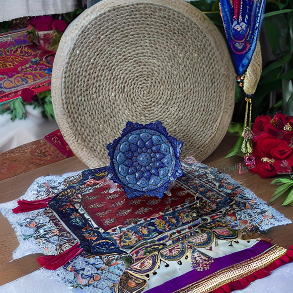 A professional product display shot of the 16 cm turquoise and deep blue petal Minakari copper plate positioned against a woven backdrop.