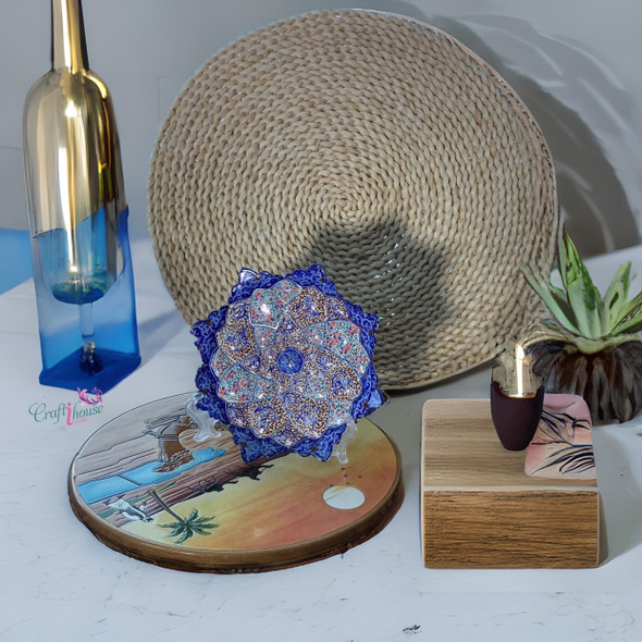A professional product display shot of the 16 cm blue and orange floral Minakari copper plate positioned against a textured rustic background.