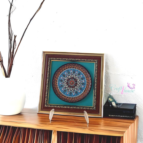 A traditional Iznik style blue ceramic display plate beautifully enclosed in a luxury frame hanging on a feature gallery wall.