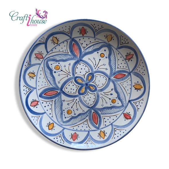 A professional product shot of the 30 cm Moroccan plate styled elegantly on an ochre textured surface.