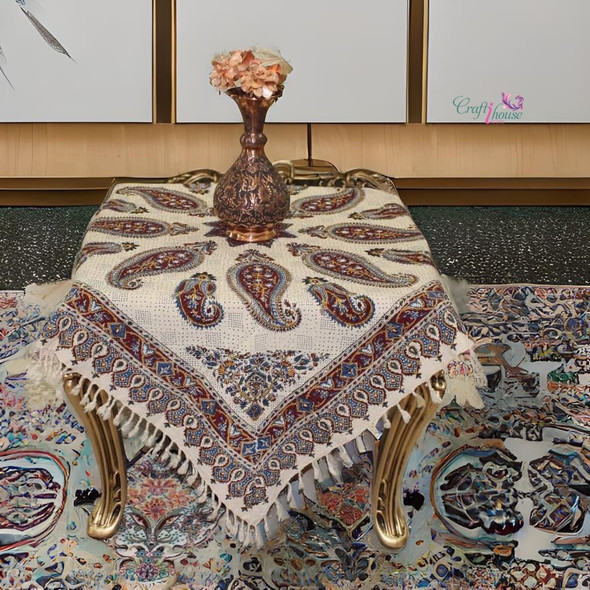 A detailed close-up highlighting the soft cotton weave, intricate hand-printed paisley patterns, and traditional tassel fringe of the Ghalamkari table cloth.