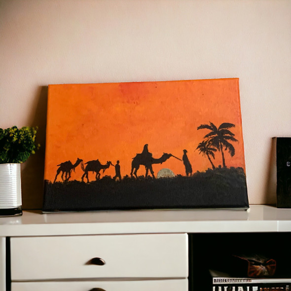 Close-up view of the detailed silhouette figures of camels and travelers journeying across the textured orange-toned canvas.