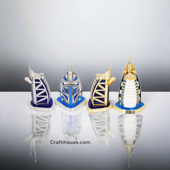Craftihouse Burj Al Arab architectural models, showing four variations lined up on a white background, highlighting the helipad detailing and bases stamped with "DUBAI".