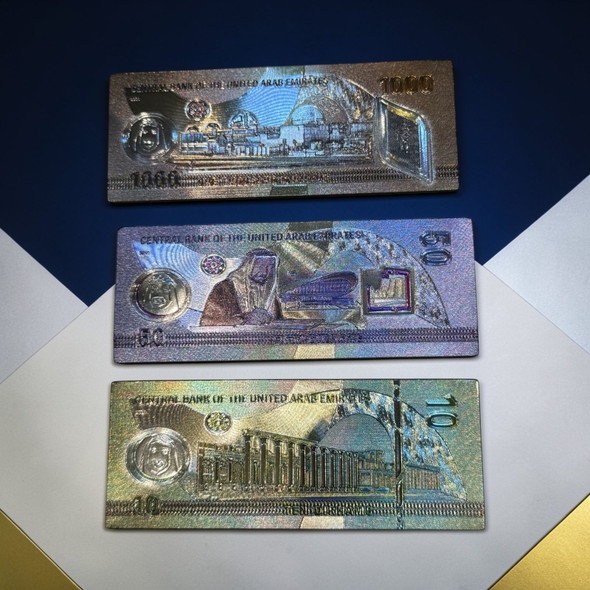 A set of 3 fridge magnets designed as UAE currency banknotes, measuring 9x3.5 cm each.