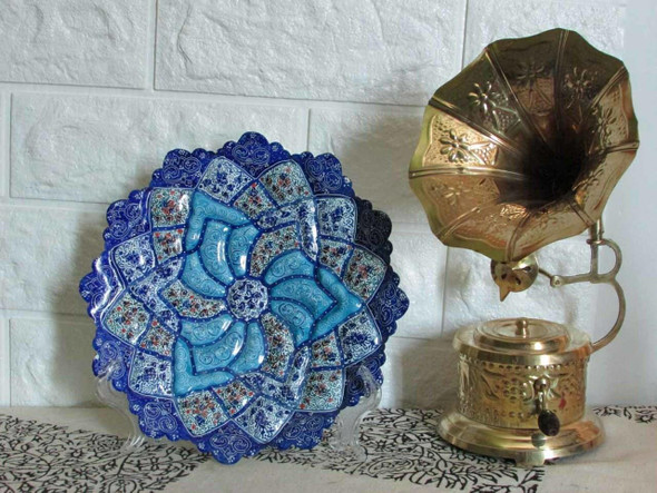 A premium 20 cm hand-painted Meenakari copper wall plate titled "The Sapphire Blossom" featuring vibrant dark blue, blue, and white floral relief patterns.