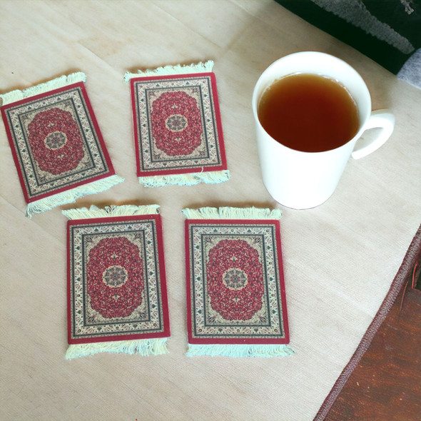 A stylish tabletop display of the carpet pattern tea coasters alongside a ceramic coffee mug.