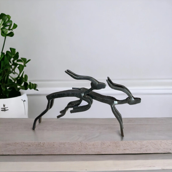 A stylish tabletop metal deer sculpture set showcasing minimalist artistic expression and clean lines.