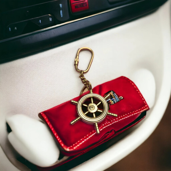 A detailed look at a high-quality brass ship wheel accessory, perfect for nautical enthusiasts.