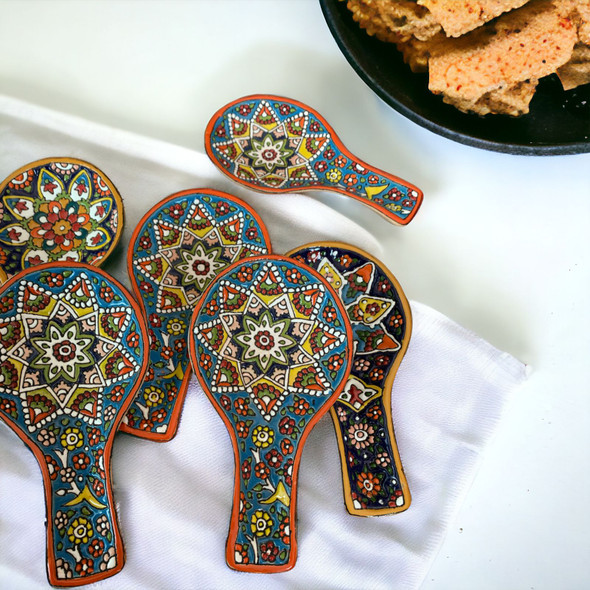 A premium 19.5 cm handmade enamel painted ceramic spoon rest titled "The Culinary Canvas" featuring vibrant raised floral patterns.