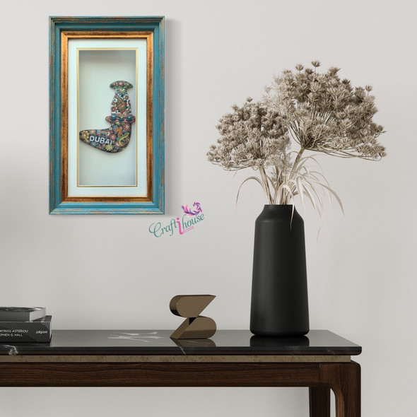 A premium 48x28 cm framed clay Dubai dagger titled "The Heritage Khanjar" featuring vibrant hand-painted pottery relief art.