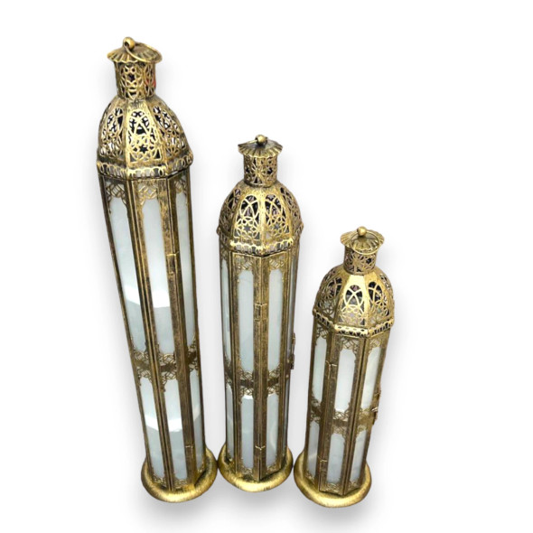 Close-up of intricate antique gold metalwork and glass panels on decorative lanterns.
