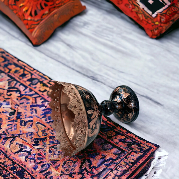 A close-up view of the fine hand-engraved patterns on this decorative 16 cm copper piece.