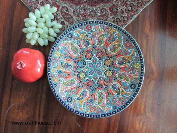 A premium 25 cm handmade enamelled pottery plate featuring vibrant Moroccan-style hand-painted floral patterns and a high-gloss finish.