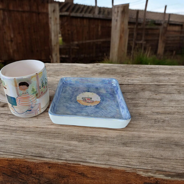 A professional product presentation of the exclusive hand-painted ceramic remote worker mug set from a premier UAE gift shop.