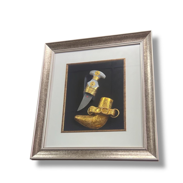 A professional product shot of the 48x43 cm framed traditional dagger art styled elegantly on a wooden surface.