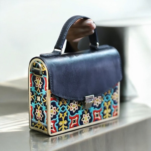 The hand-painted wood bag styled as a luxury fashion accessory, emphasizing its unique blend of art and functional design.