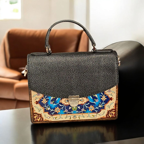 Luxury artisanal gift: Hand-painted leather handbag with carved wooden sides and circular handle, crafted by Craftihouse Dubai