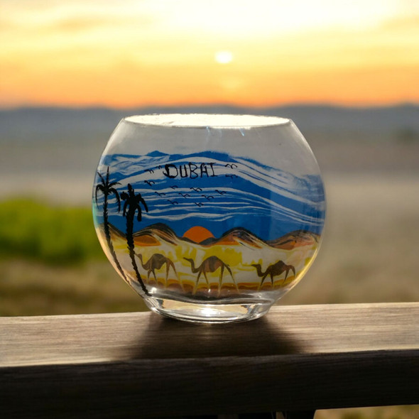 A large 20x16 cm flat glass sand art bottle featuring an expansive desert landscape with a camel caravan.