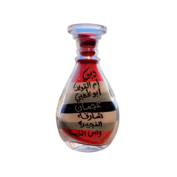 Close-up of the distinct sand layers and desert landscape representing the seven Emirates in a 10 cm bottle.