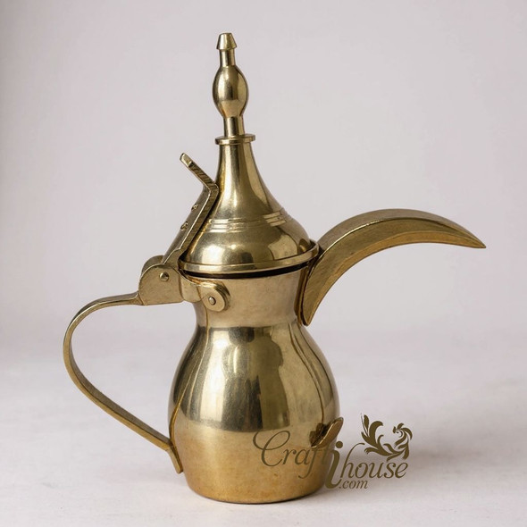 Close-up of the polished brass finish and the decorative hinged lid of the miniature Arabic Dallah.