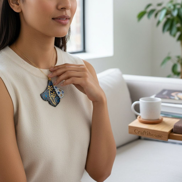 Close-up view of the vibrant enamel work and detailed floral design on our Minakari copper pendant.