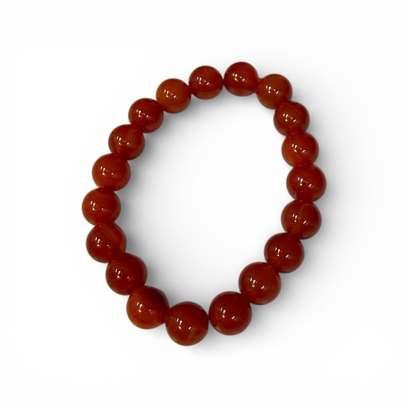 A circular stretch bracelet featuring polished round stone beads in various shades of reddish-orange and amber on a clean white background