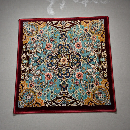 A 30x30 cm vibrant red silk table mat with a traditional Persian floral medallion and gold accents