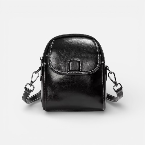 Close-up of the genuine cow leather texture and high-end stitching on the black Craftihouse mini shoulder bag.