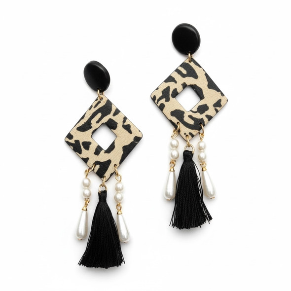 A pair of handcrafted geometric rhombus earrings with leopard print, accented by ivory pearls and long black tassels.