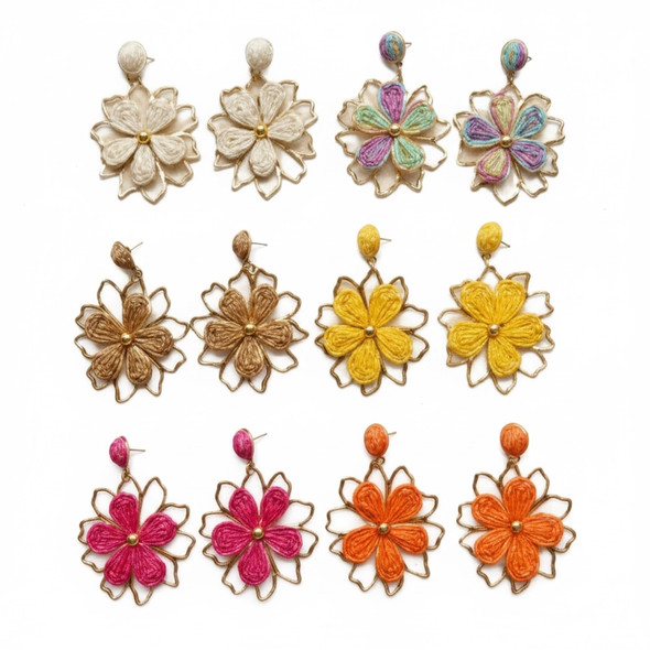 A pair of handcrafted teal clay teardrop earrings featuring an assorted collection of 3D sculpted flowers in white, blue, and yellow.