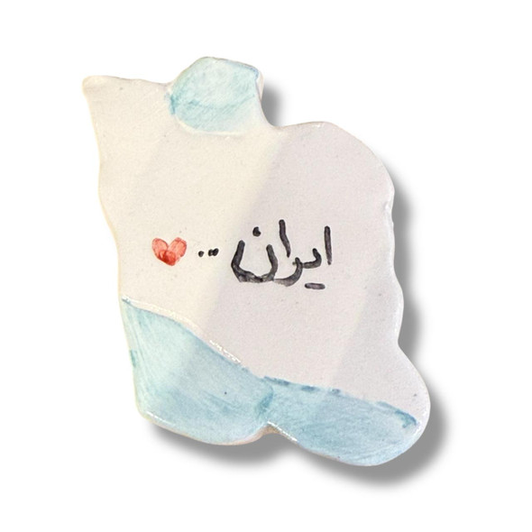 A 6.5x4.5 cm ceramic magnet shaped like the map of Iran with "Iran" written in Persian calligraphy.