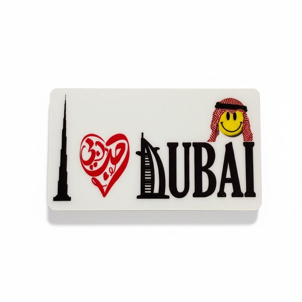 A 6.5x3.5 cm aluminum fridge magnet featuring a smiling Arab man emoji and the "I Love Dubai" message.