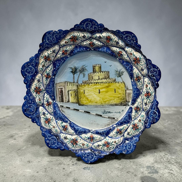 A 16 cm hand-painted Minakari copper plate featuring a traditional UAE fort and castle pattern with a blue floral border.