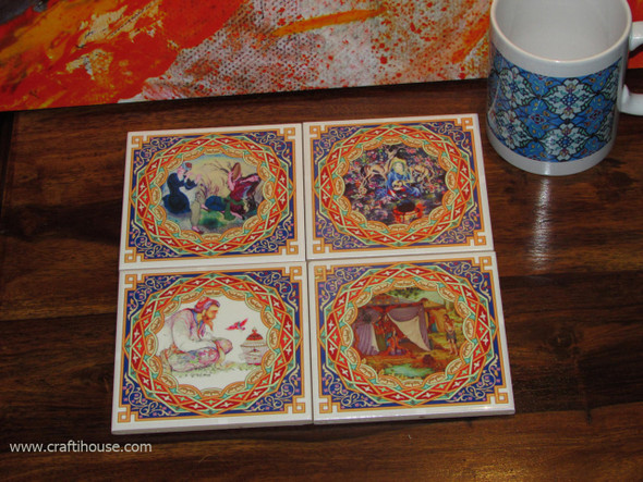 An artisan ceramic tea coaster set featuring timeless miniature painting artwork, perfect for adding a touch of heritage and color to any home decor setting.
