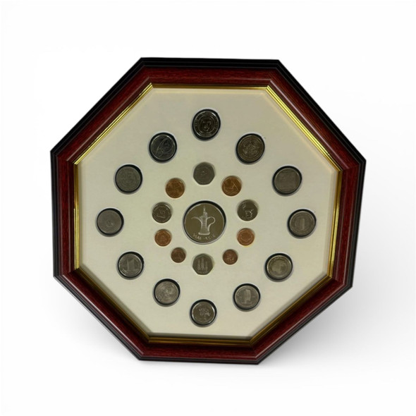 Close-up of the genuine 1 Dirham and various UAE denominations inside the hexagonal shadow box frame.