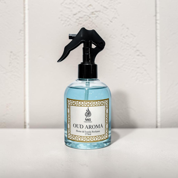 Studio presentation of the NASI Perfumes Oud Aroma room fragrance mist, featuring the clear rounded bottle centered on a minimal white surface.