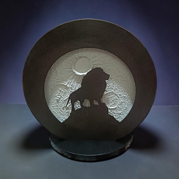 Detailed close-up of the fine sculptural lines defining the male lion silhouette and its majestic mane overlooking the decorative lunar night light layout.