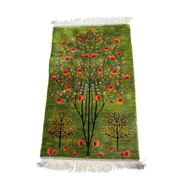 Detailed layout perspective focusing on the central tree trunks and radiant pomegranate fruits, emphasizing the rich heritage color pigments and modern loom symmetry.