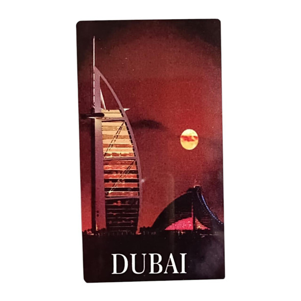 A vertical 14x8 cm aluminum fridge magnet showcasing the Burj Al Arab silhouette against a deep red night sky and a full moon with "DUBAI" text at the bottom.