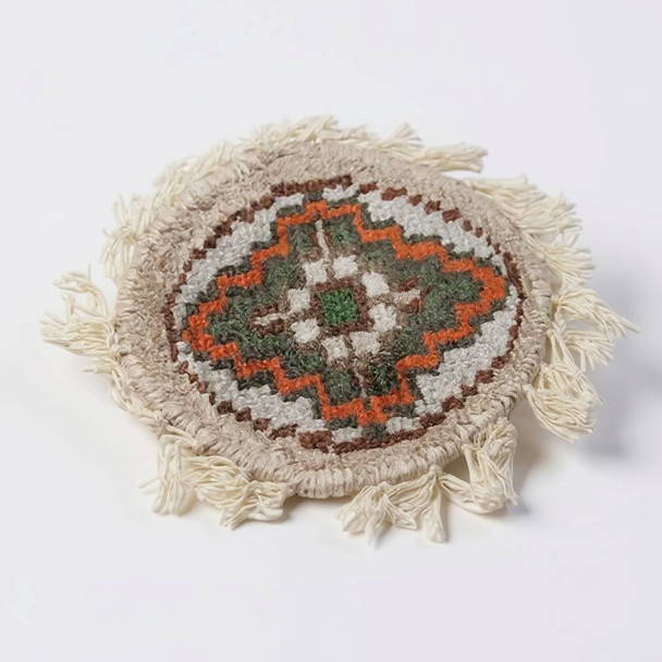 High-quality round tea coasters that mimic the look and feel of traditional carpets, sized at 9-10 cm.