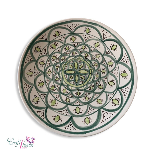 A large Moroccan earthenware plate with blue and yellow geometric patterns used for serving appetizers