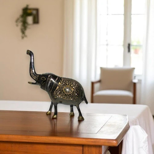 A premium 16x8 cm handmade engraved brass elephant statue titled "The Golden Matriarch" featuring intricate hand-etched floral patterns.