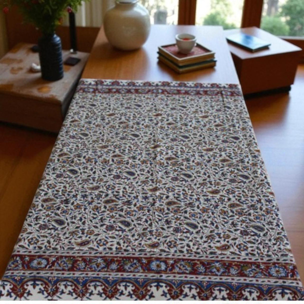 A premium 100x100 cm handmade cotton tablecloth titled "The Meadow Square" featuring dense indigo and red block-printed floral patterns.